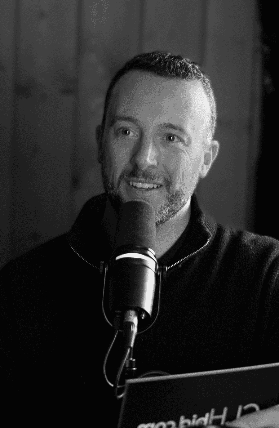 Devon Davidson smiling and looking to the left during recording of a podcast